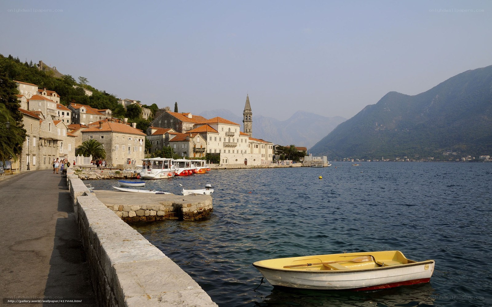 Coastal town with boats and mountains
