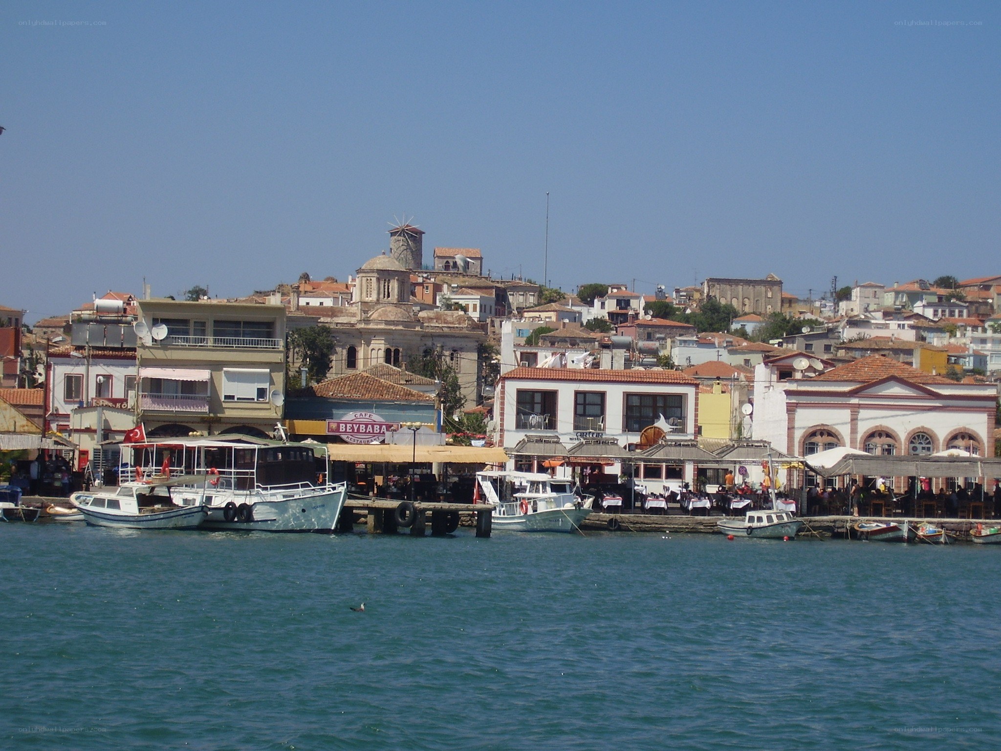 coastal town with boats and windmill