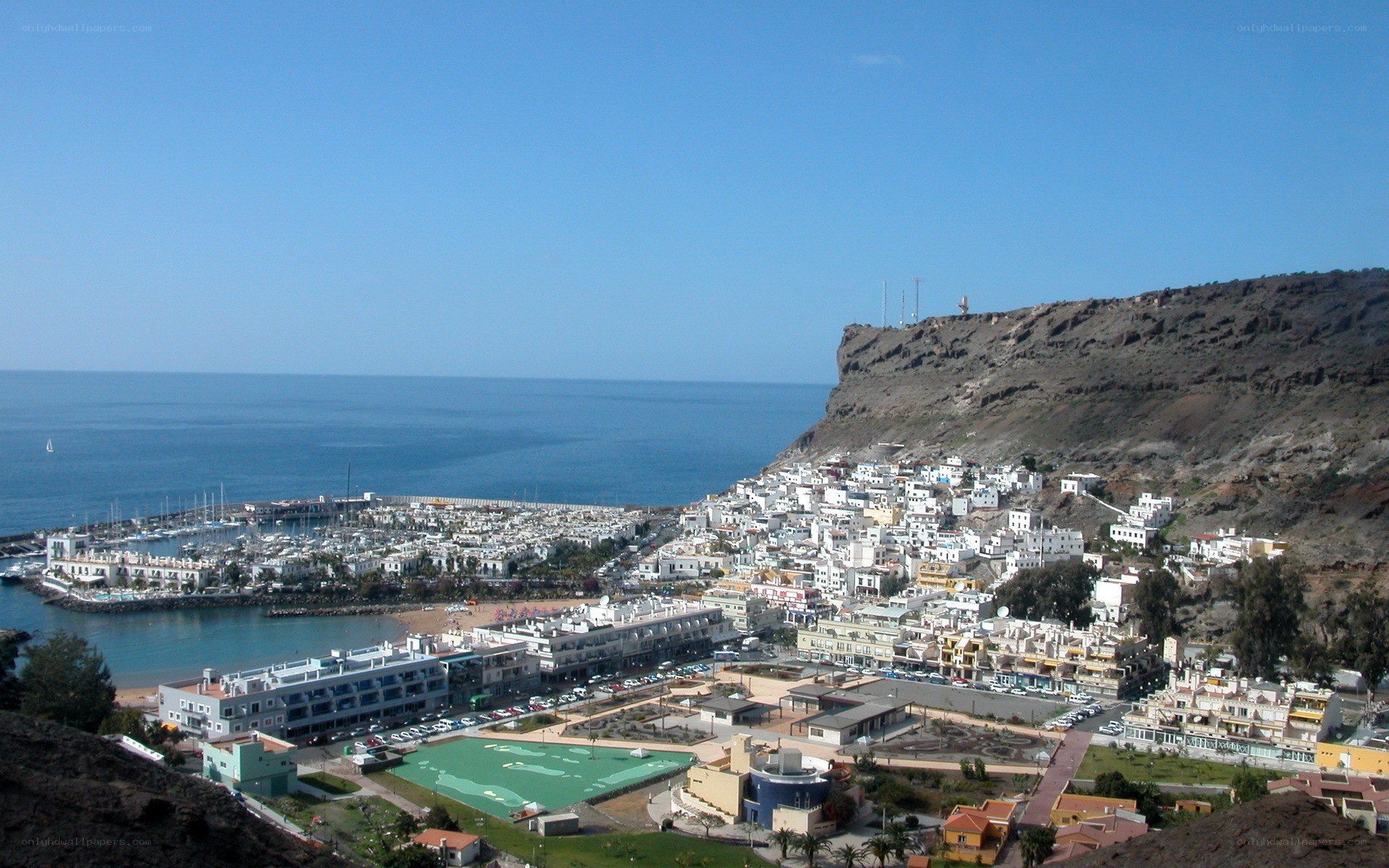 coastal town with harbor and cliffs
