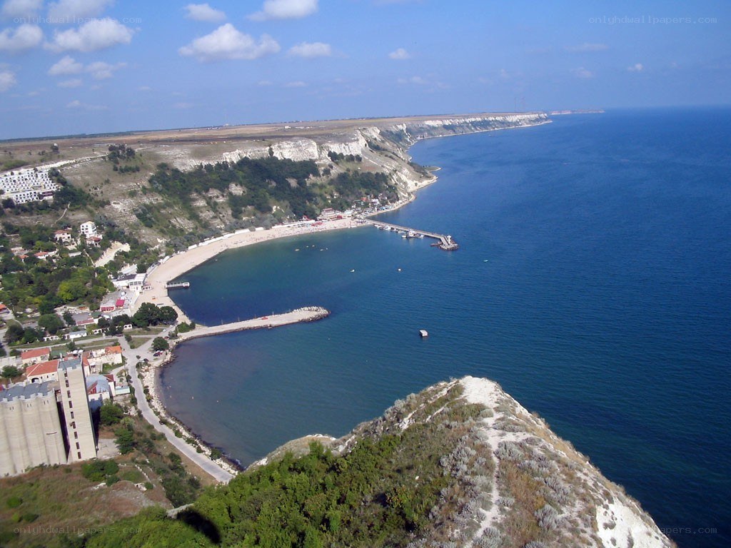 coastal town with harbor and cliffs