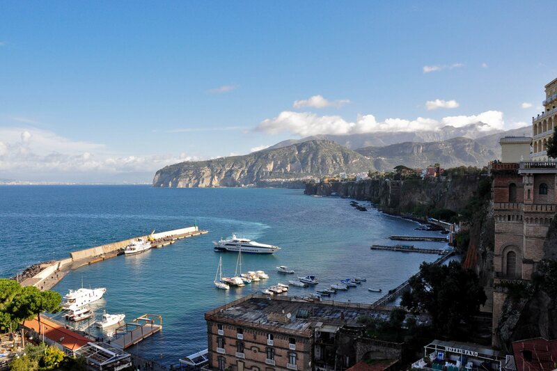 coastal town with harbor and mountains