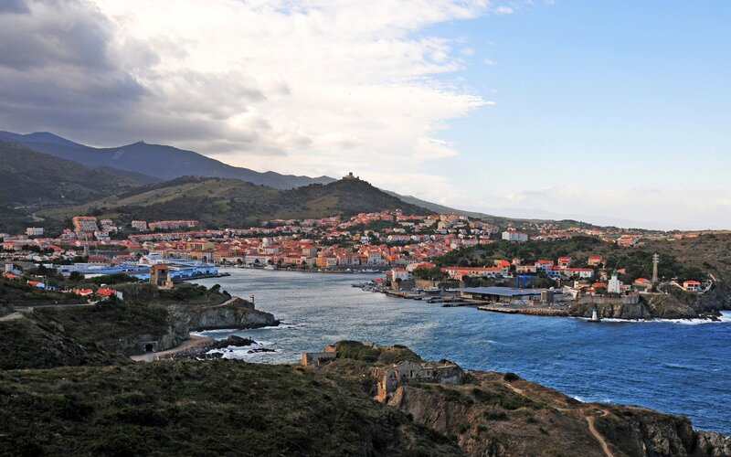 coastal town with harbor and mountains