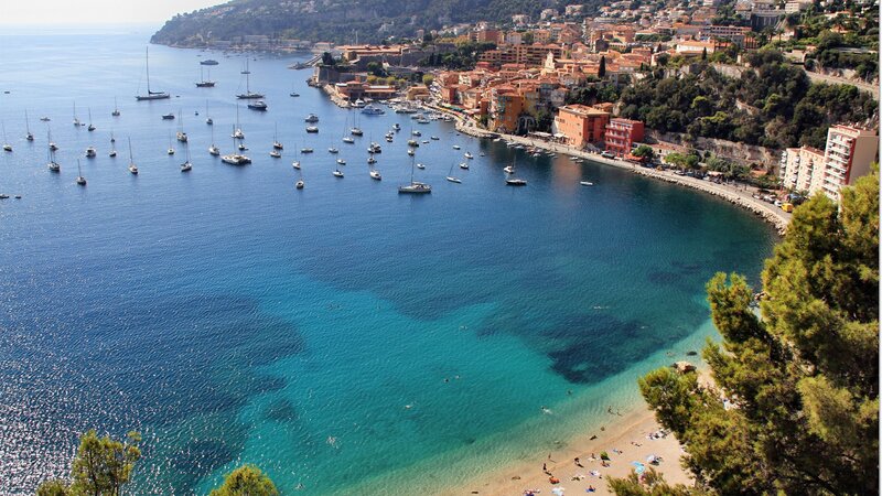 Coastal Town with Harbor — Blue, Serene, Afternoon, Photograph, Boats, Beach