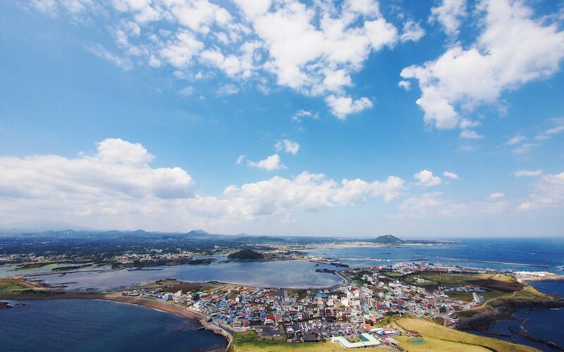 Coastal Town with Harbor — Blue, Serene, Afternoon, Photograph, Sea, Clouds