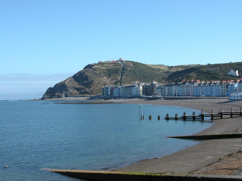 coastal town with hill and pier