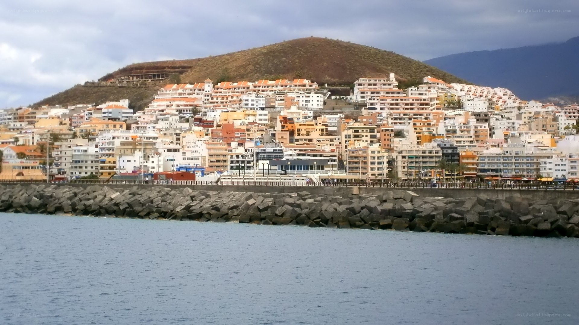 coastal town with hill backdrop