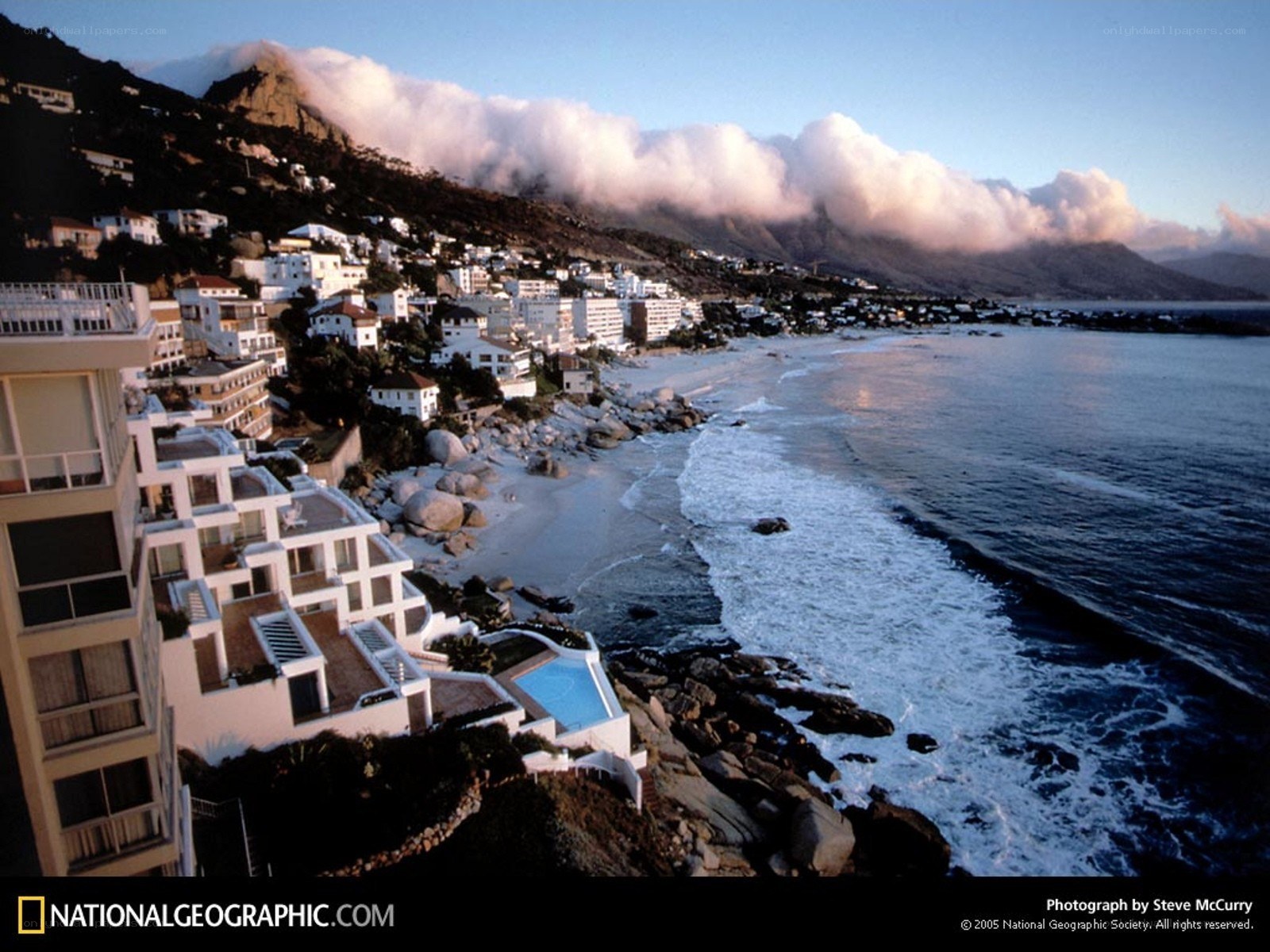 Coastal town with mountain backdrop