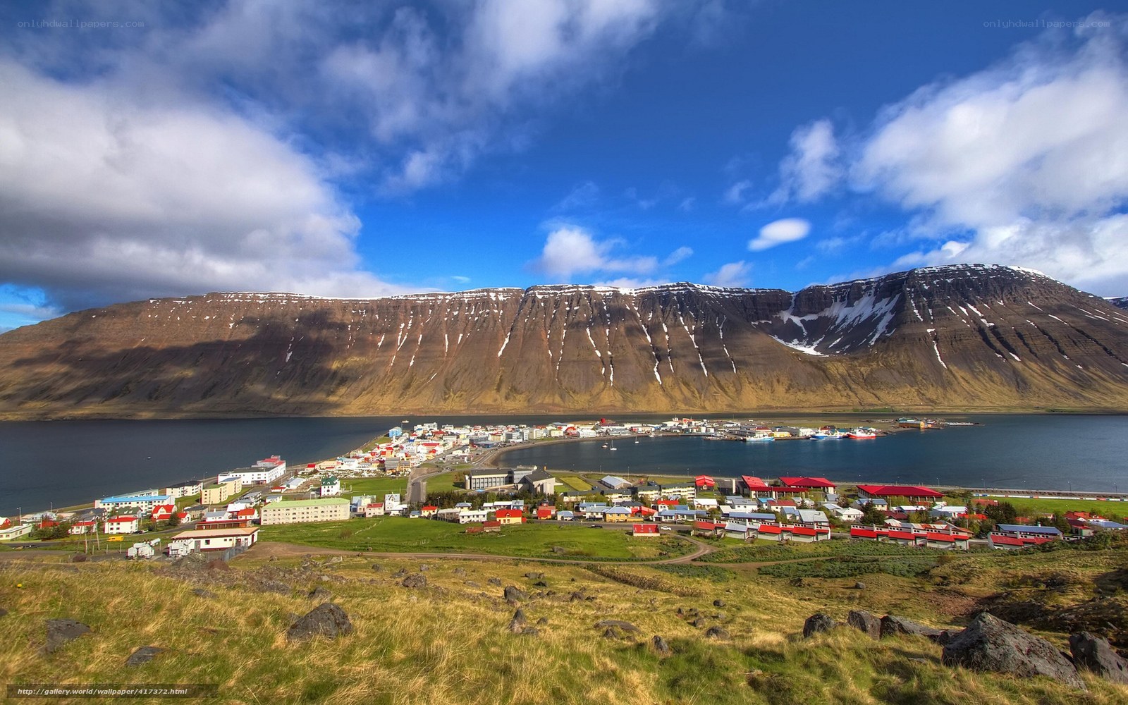 Coastal town with mountain backdrop