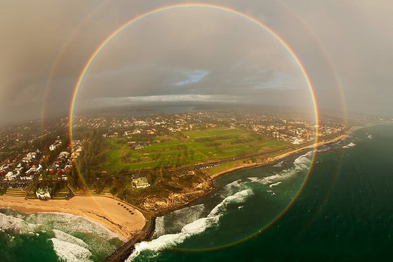Coastal Town with Rainbow