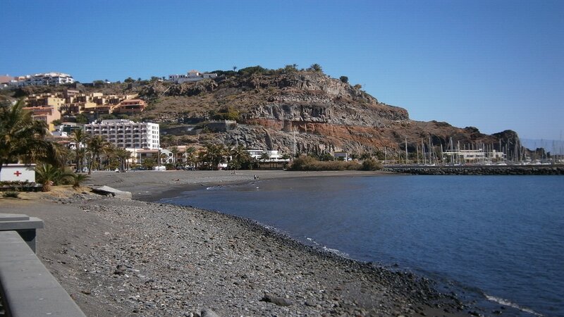 coastal town with rocky hill