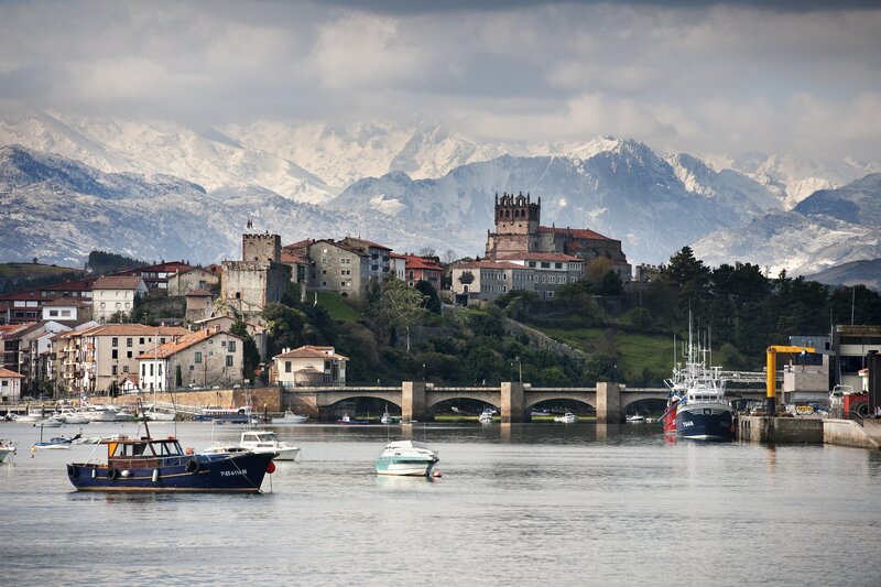 Coastal town with snow-capped mountains