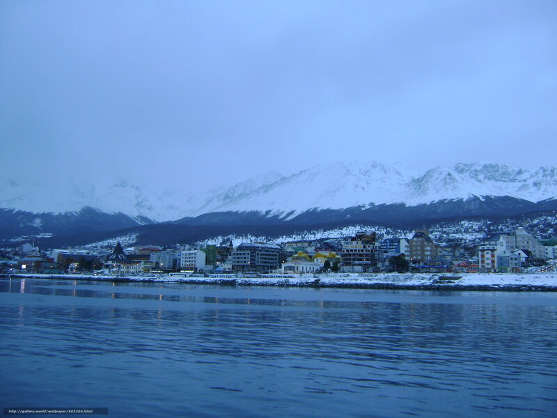 coastal town with snow-capped mountains