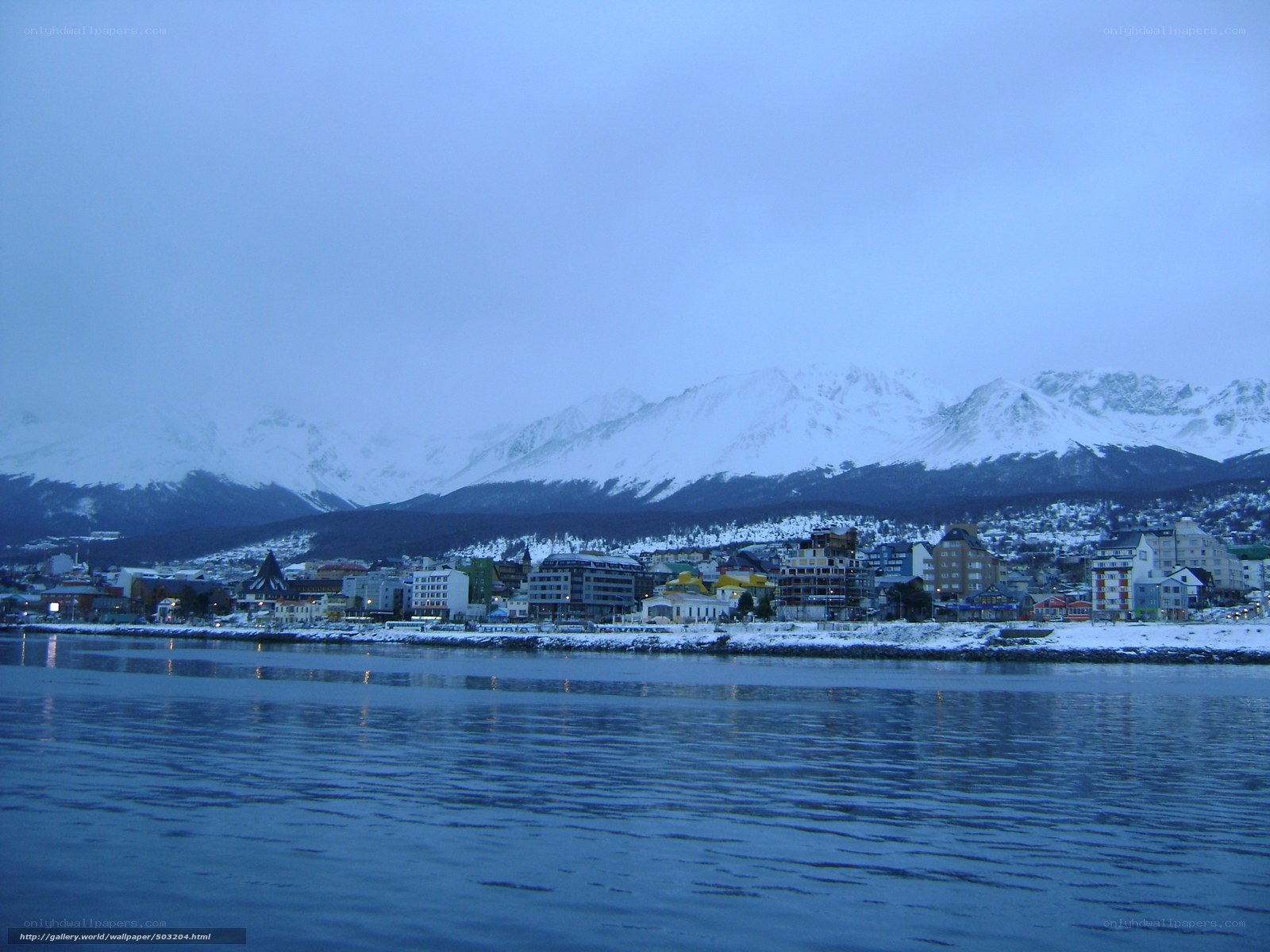 coastal town with snow-capped mountains