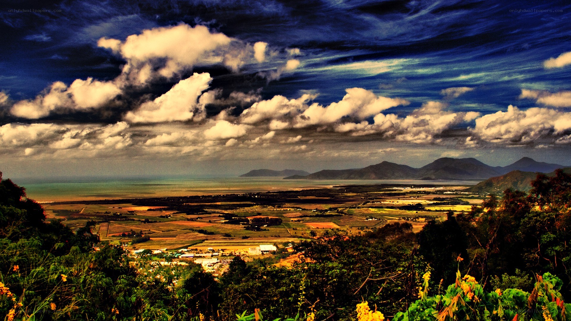 Coastal valley under dramatic sky