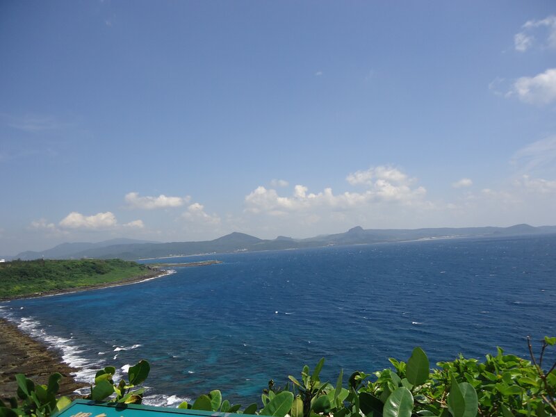 coastal view of green hills and blue sea