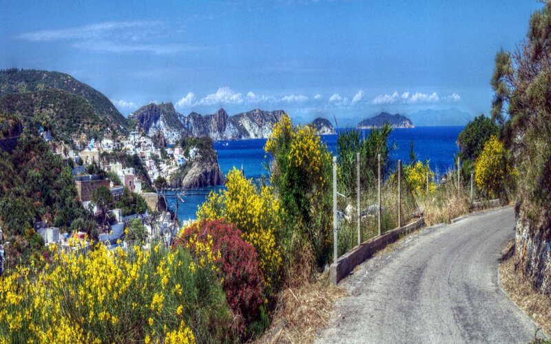 Coastal Village on Hillside — Blue, Serene, Afternoon, Photograph, Sea, Mountains