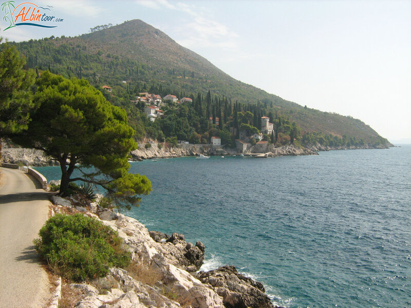 Coastal Village on Hillside — Blue, Serene, Afternoon, Photograph, Sea, Road