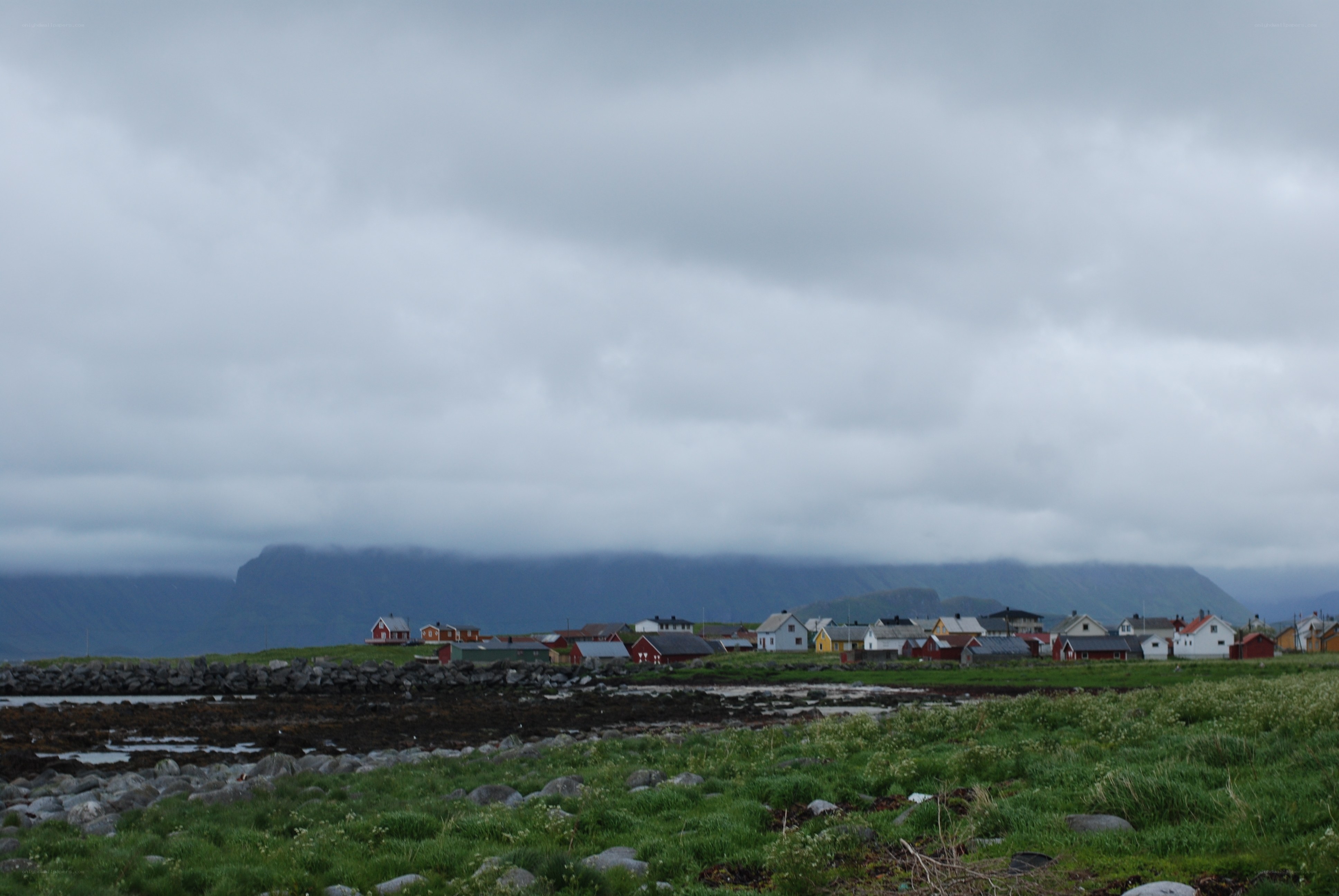 Coastal village under cloudy sky