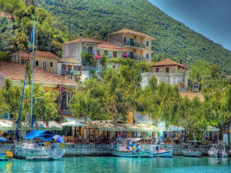 Coastal village with boats and mountains