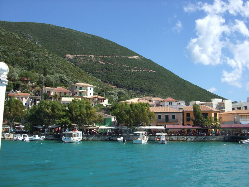 Coastal village with boats and mountains