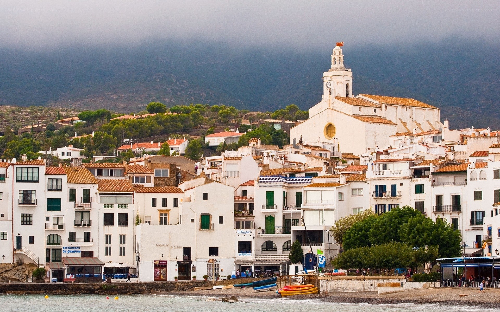 Coastal village with church and mountains