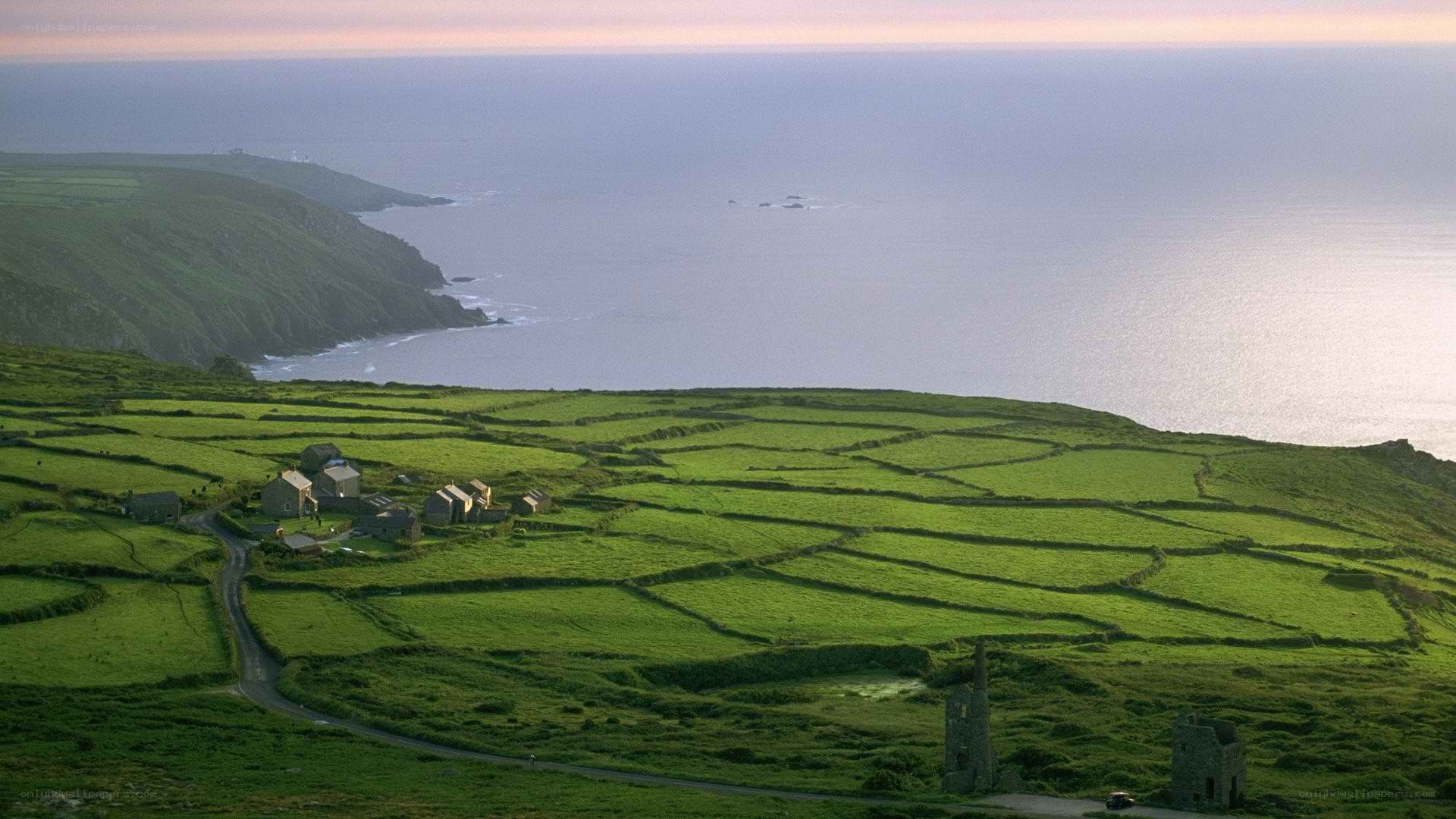 Coastal village with green fields