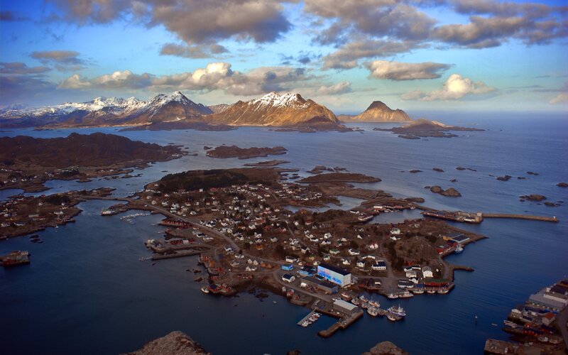 Coastal village with snow-capped mountains