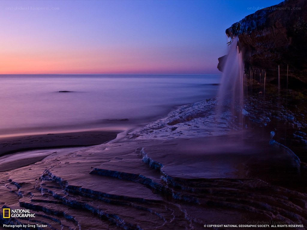 Coastal waterfall at dusk
