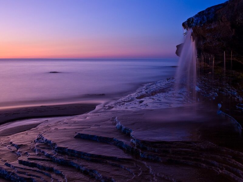 coastal waterfall at dusk