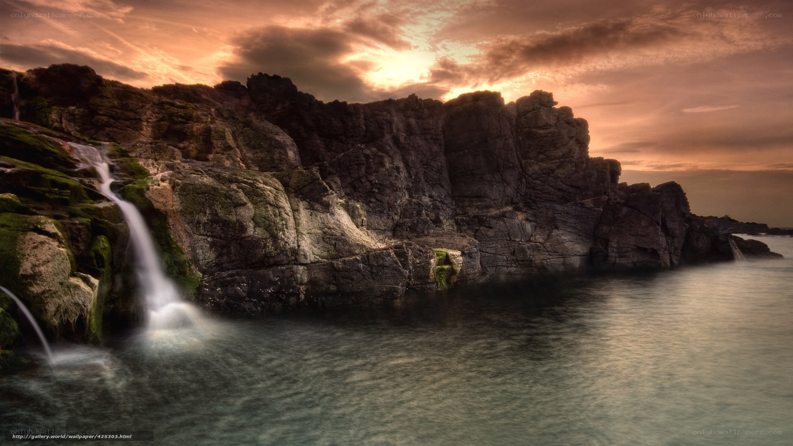 Coastal waterfall at sunset