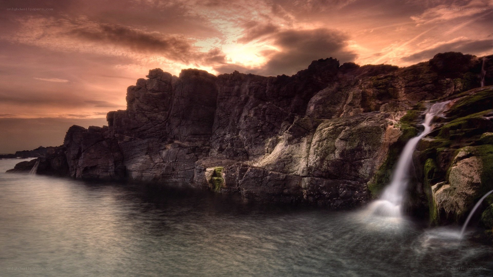 coastal waterfall at sunset