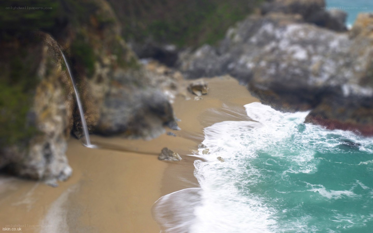 coastal waterfall on sandy beach