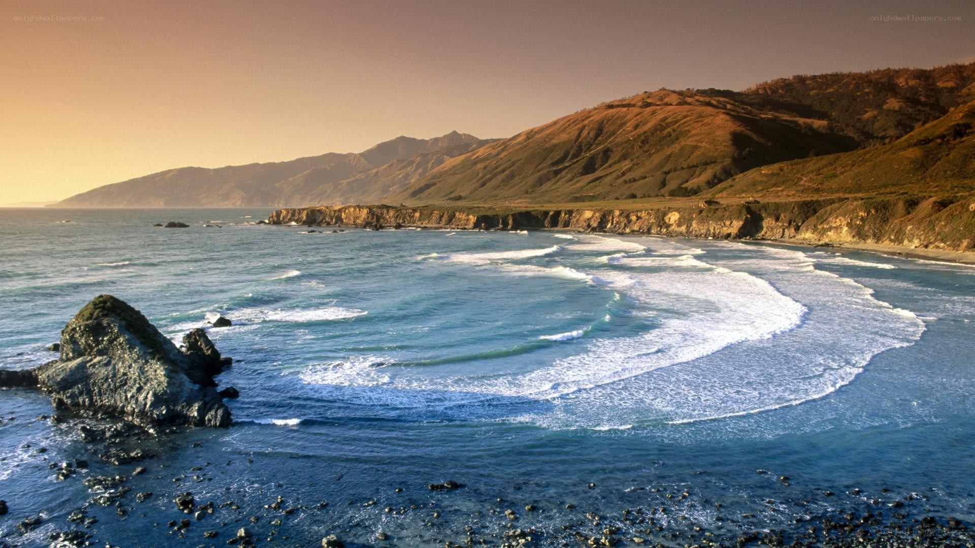 coastal waves and cliffs at sunset