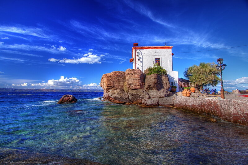 Coastal white house on rocky outcrop