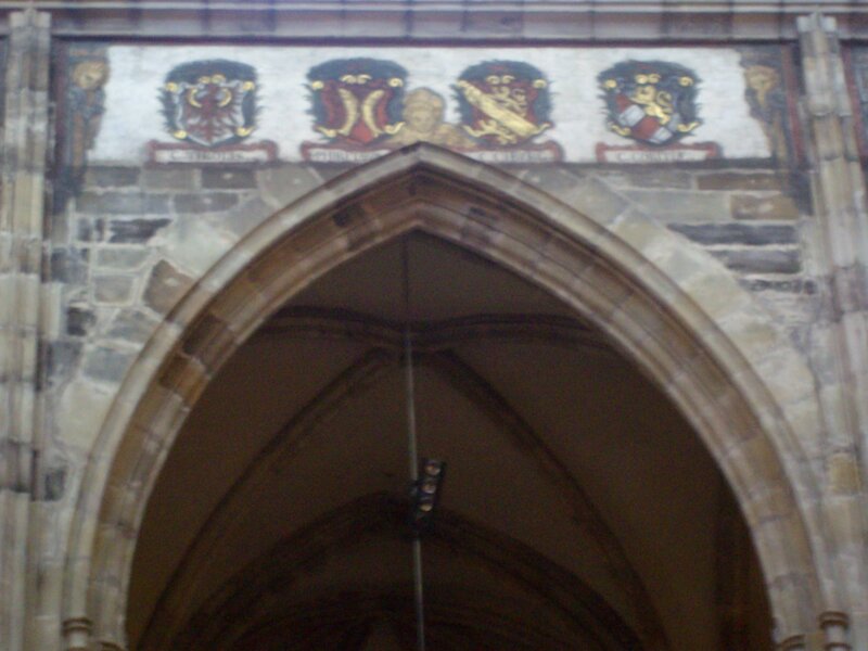 coats of arms above an arch