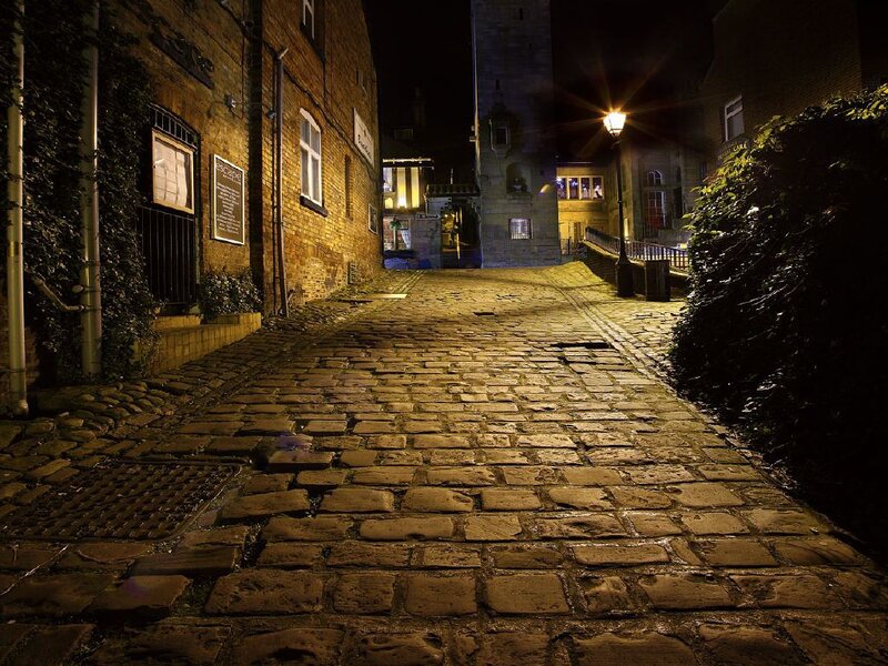 cobblestone alley at night
