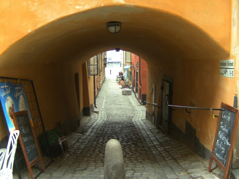 Cobblestone Alley under Arch