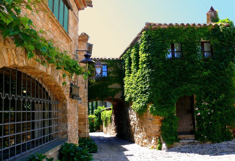 cobblestone alley with ivy-covered buildings