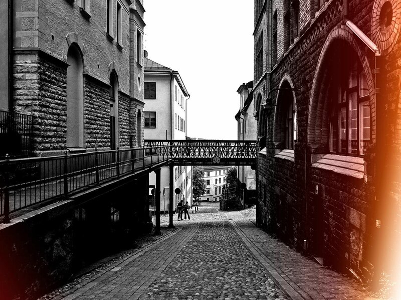 Cobblestone alley with pedestrian bridge