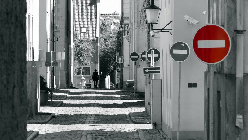 Cobblestone alley with traffic signs