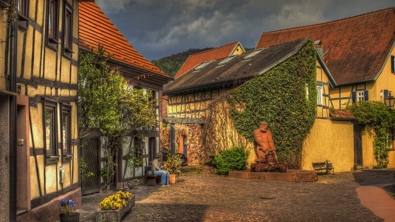 Cobblestone courtyard with timber houses