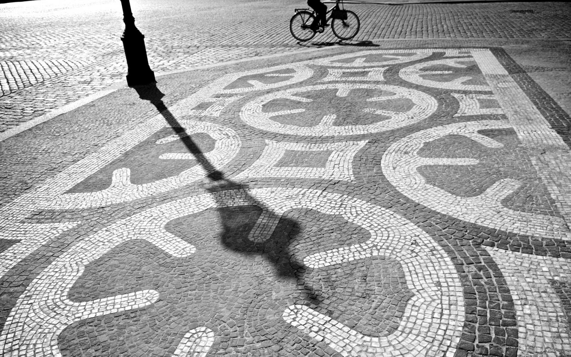 Cobblestone mosaic and bicycle shadow