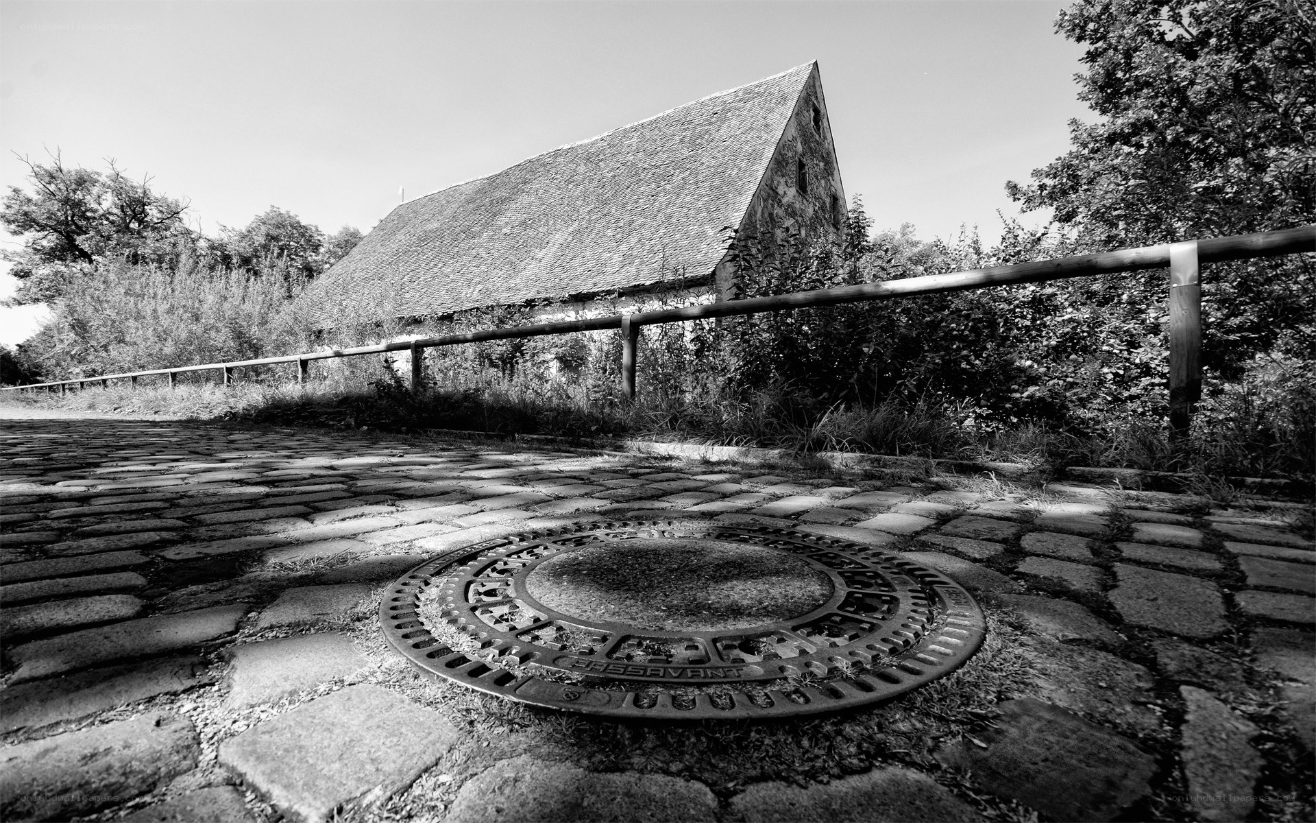 Cobblestone path with manhole cover