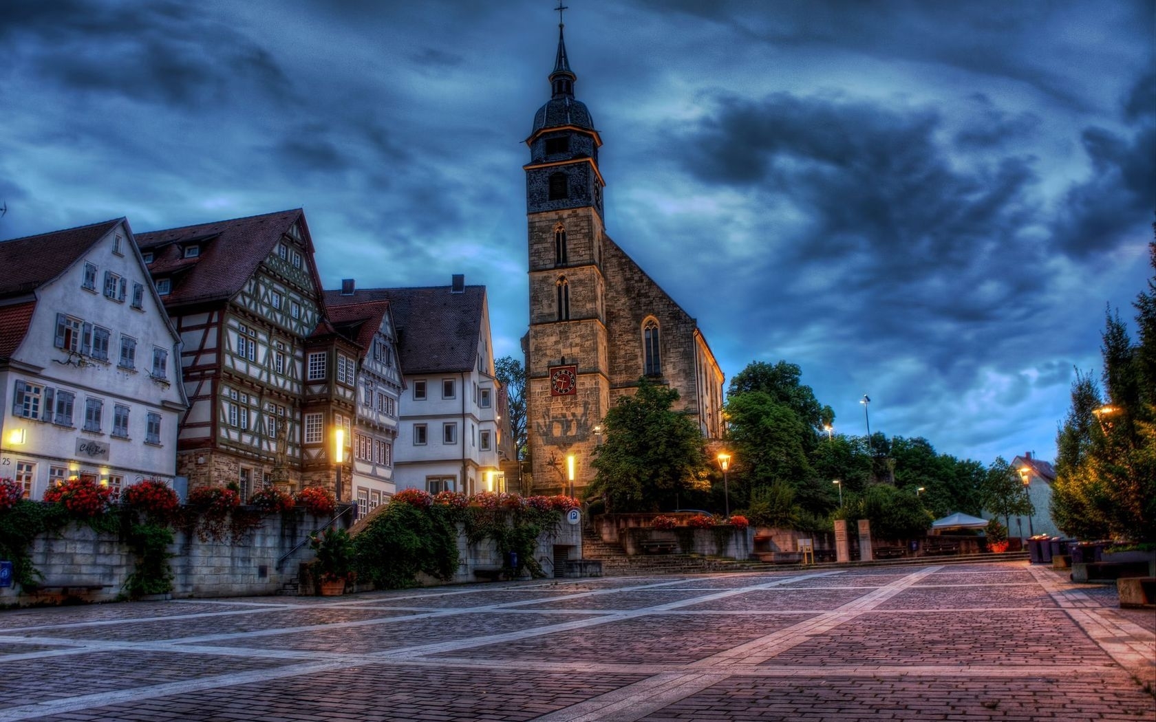 Cobblestone square with church at dusk
