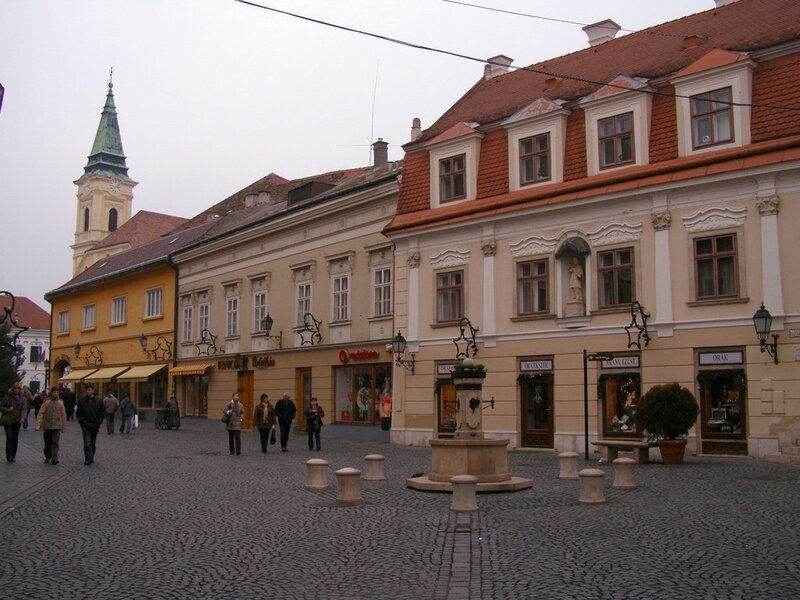 Cobblestone square with fountain and church