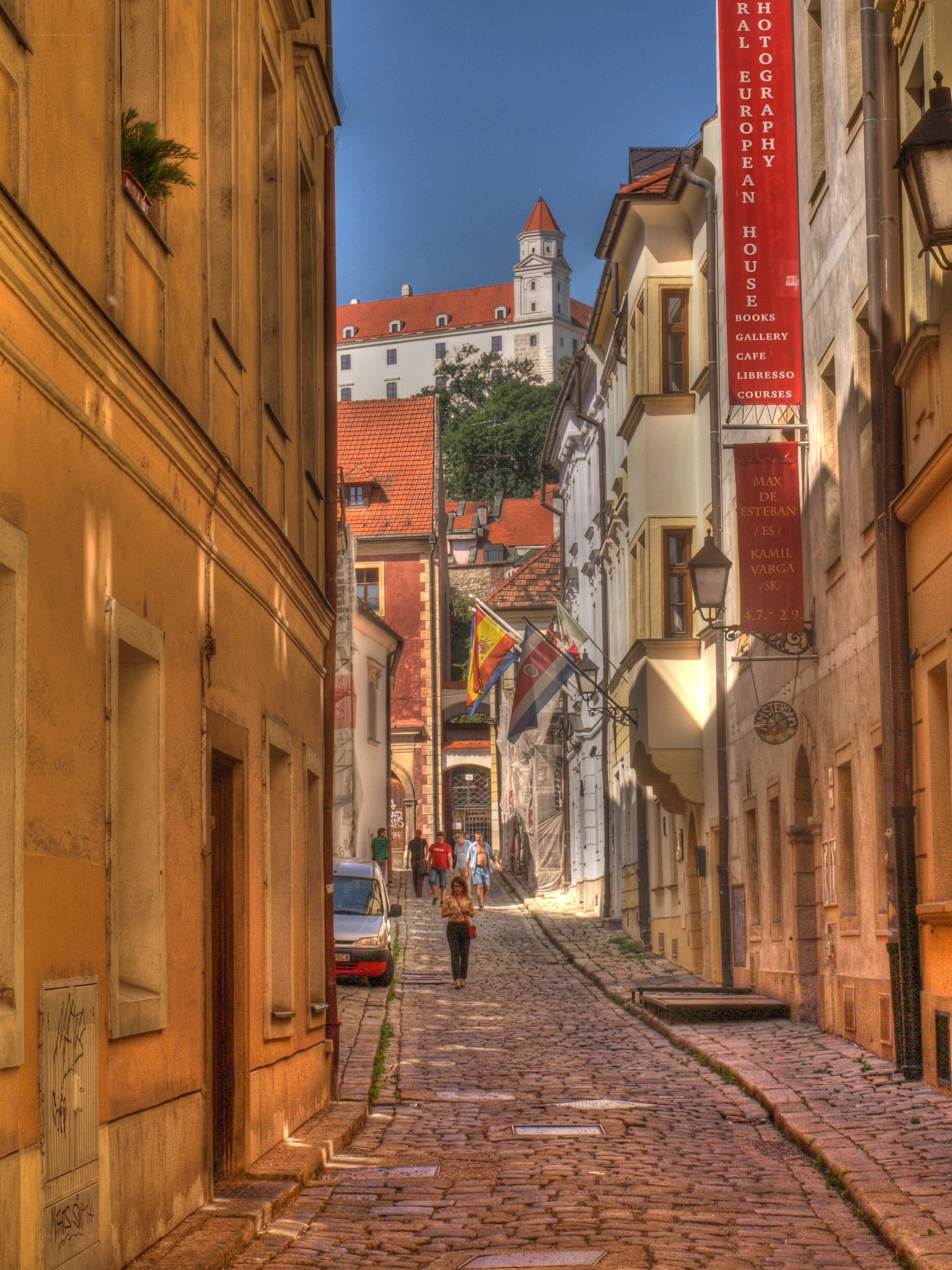 Cobblestone street with castle in background