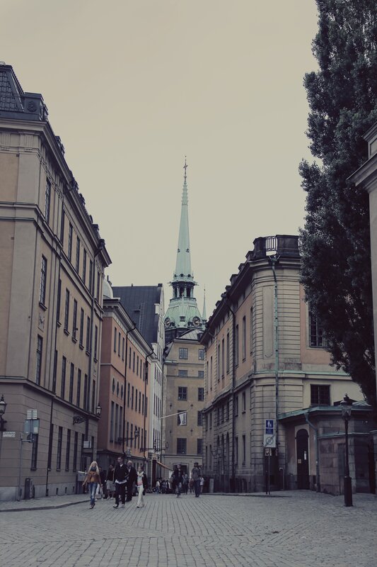 Cobblestone street with church spire