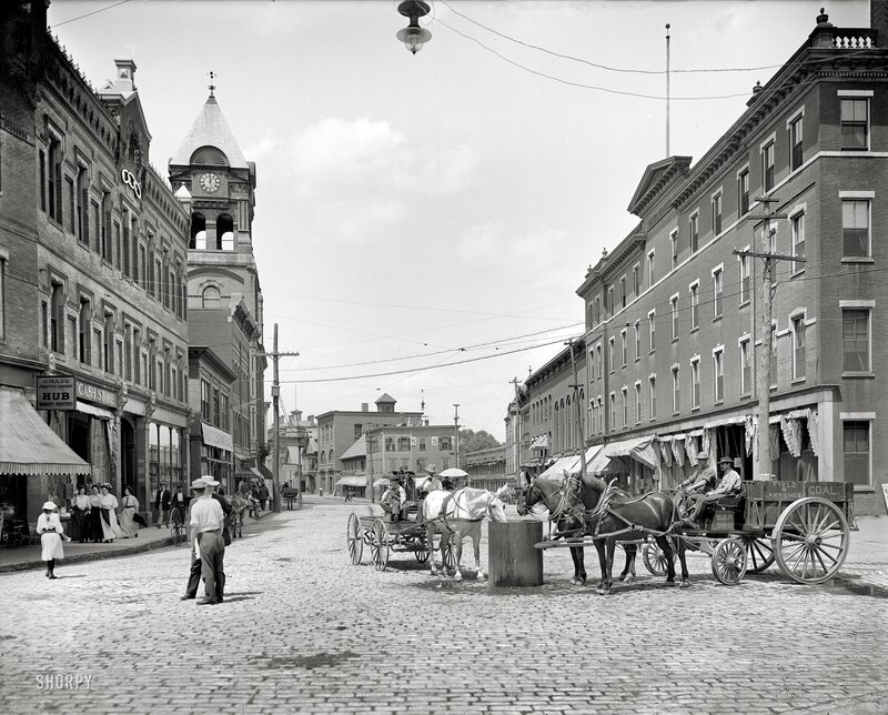 Cobblestone street with horse-drawn carriages