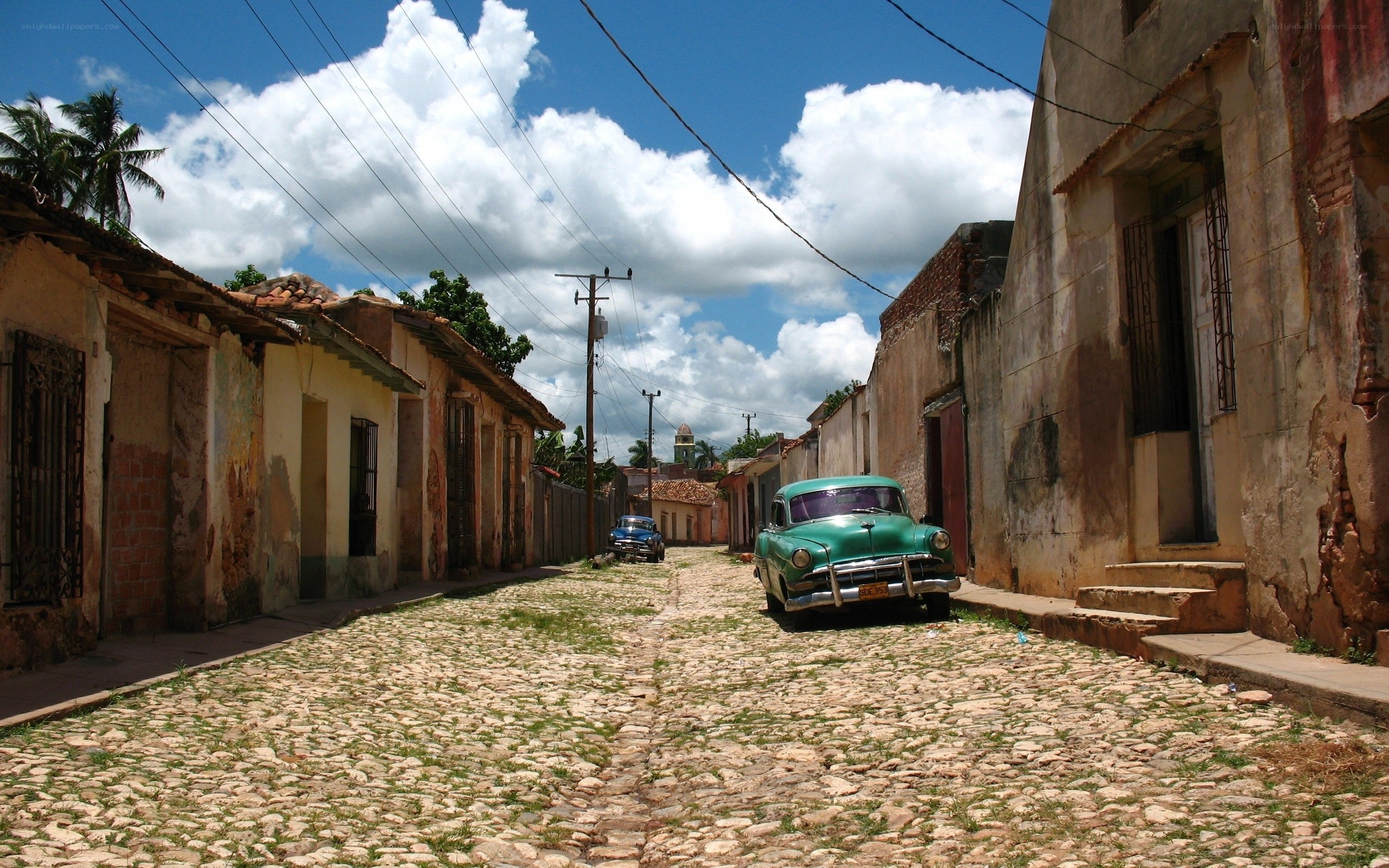 Cobblestone street with vintage cars