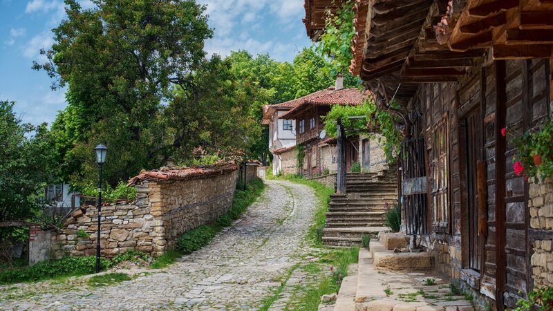 Cobblestone Village Street — Green, Serene, Afternoon, Photograph